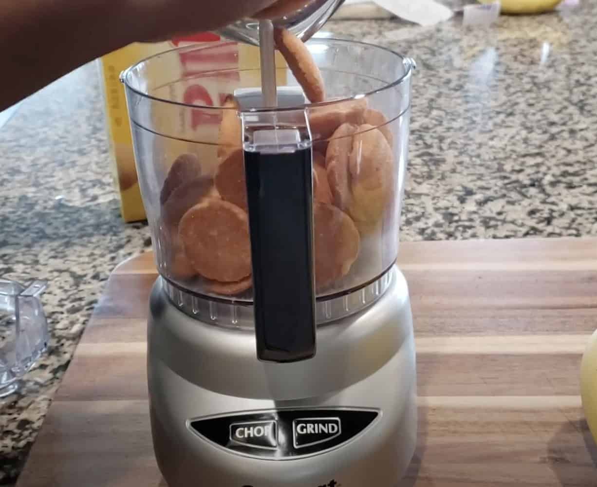 Cream-filled mini pancakes in a food processor, ready to be whipped into batter.