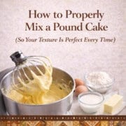 Creamy pound cake batter in a stand mixer with baking ingredients nearby.