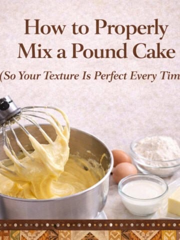 Creamy pound cake batter in a stand mixer with baking ingredients nearby.